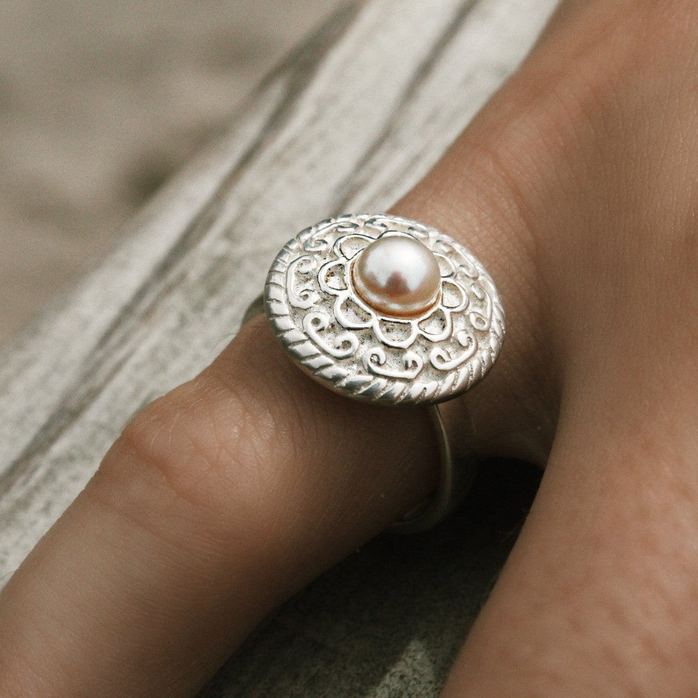 sterling silver ring with intricate details on top with cnetral pearl designed by lush deisgns jewellery broome