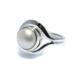 A white freshwater pearl ring set in a silver bezel, with a design reminiscent of a Cable Beach Sunset.