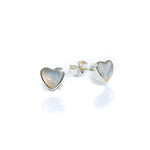 A pair of heart-shaped mother of pearl stud earrings set in sterling silver.