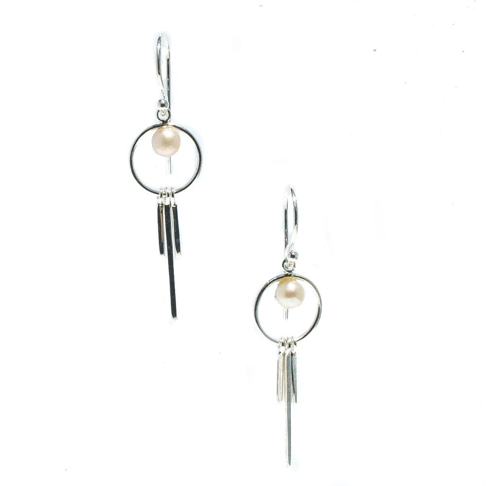 A pair of silver-colored earrings featuring freshwater pearl details, suspended from small circular hooks.