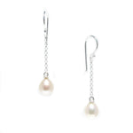 A pair of hook earrings featuring white pearls attached to silver chains.