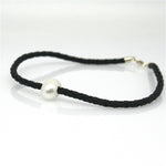 A black braid anklet with a single white pearl and a sterling silver lobster clasp.
