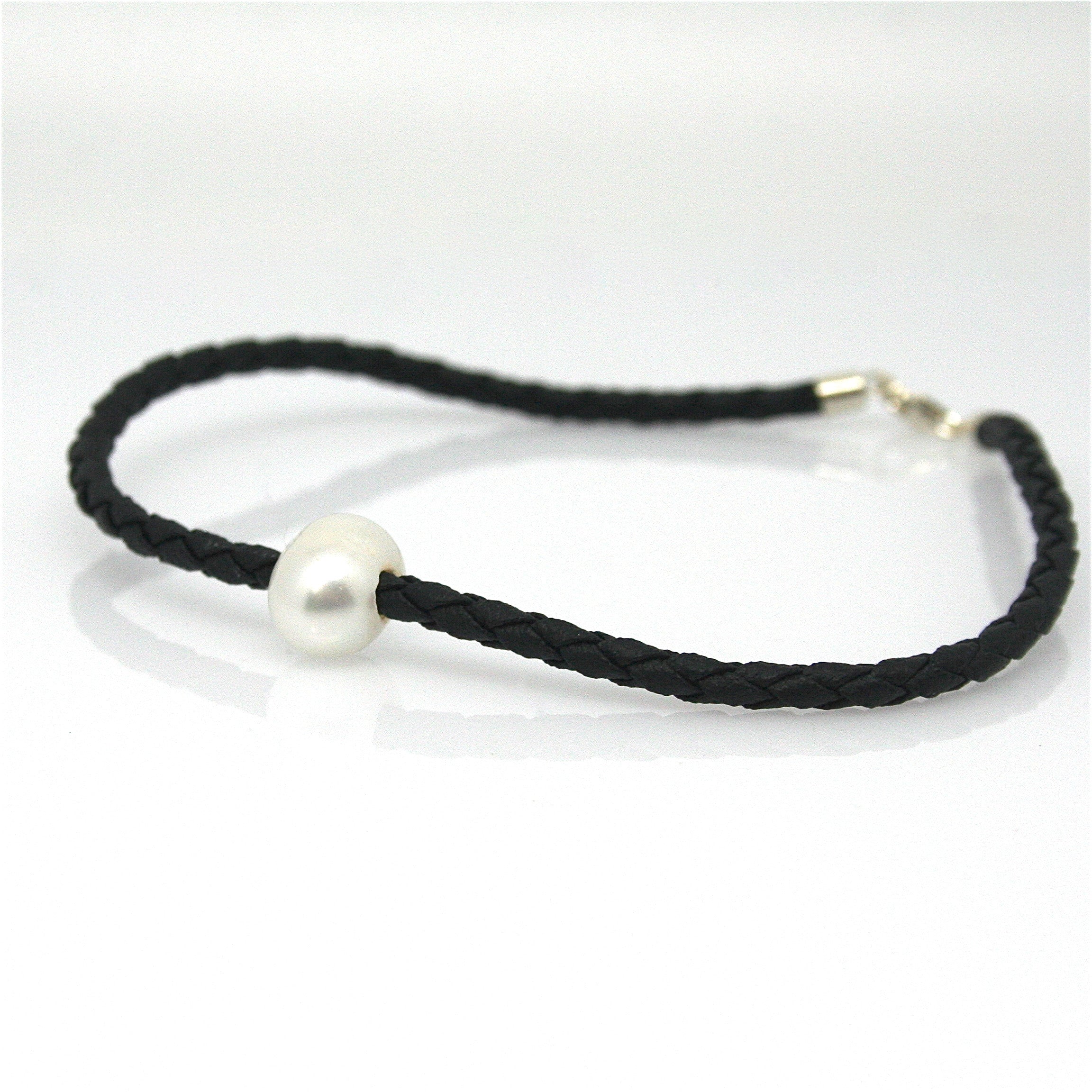 A black braid anklet with a single white pearl and a sterling silver lobster clasp.