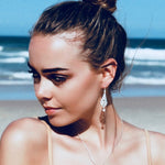 Intricate silver hook earrings with dainty white pearl 