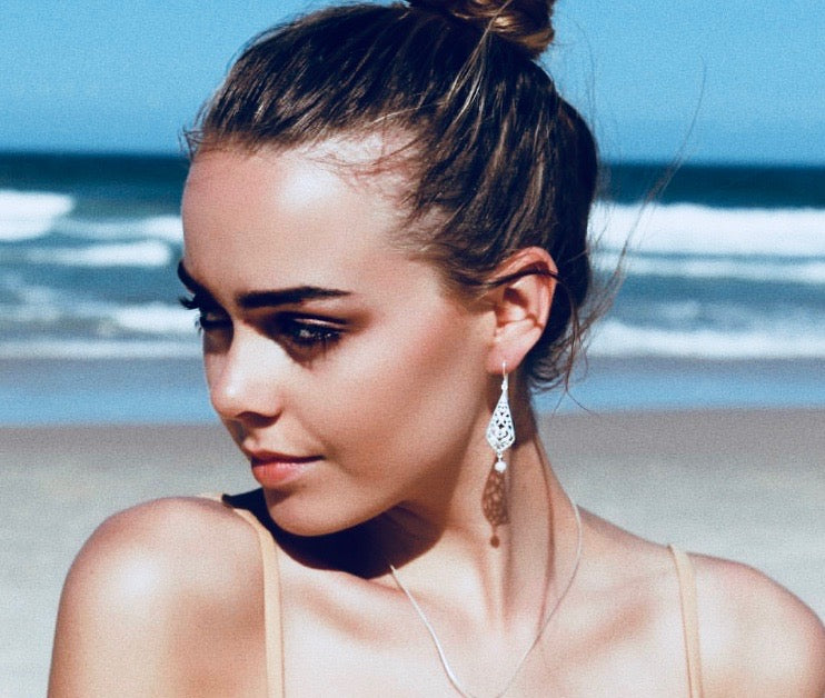 Intricate silver hook earrings with dainty white pearl 