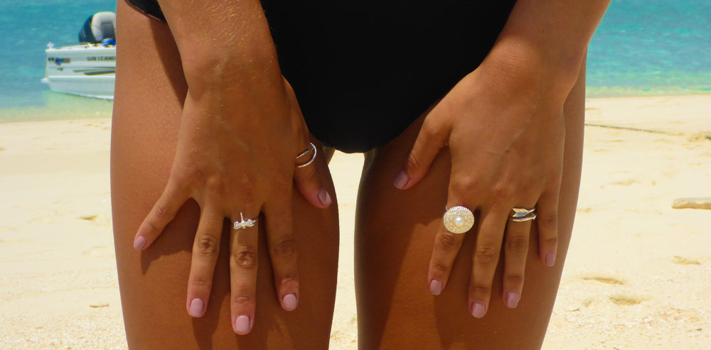 A sterling silver ring with a detailed circular design and a central white freshwater pearl
