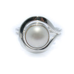 A white freshwater pearl ring set in a silver bezel, with a design reminiscent of a Cable Beach Sunset.